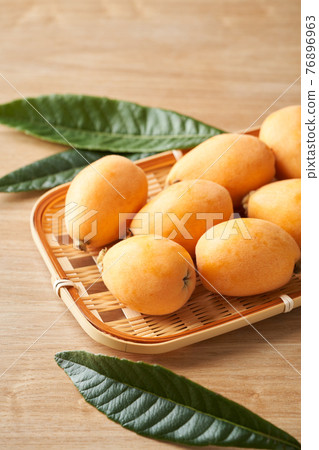 Loquat is served in a colander Loquat is served in a colander 76896963