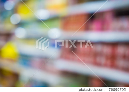 Blurred food and drink on shelf in super market with cart 76899705