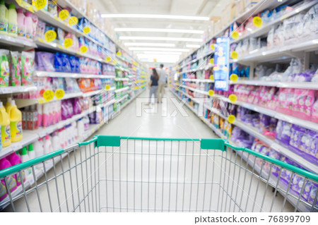 Blurred food and drink on shelf in super market with cart Blurred food and drink on shelf in super market with cart 76899709