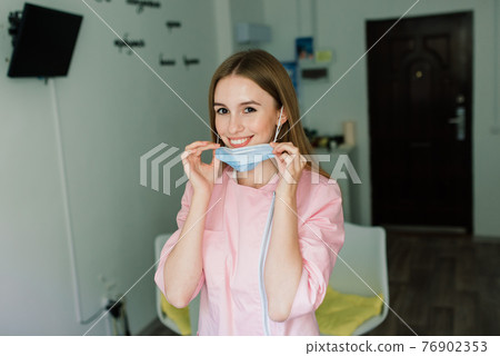 Beautiful female medical worker or manicure master in a mask 76902353