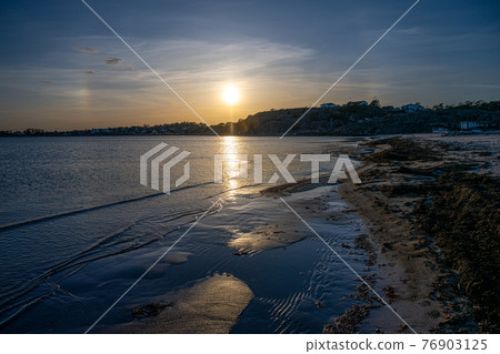 Beautiful orange sunset over an ocean bay. Picture from the Swedish west coast 76903125