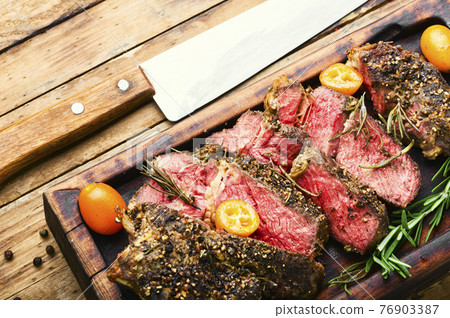 Succulent veal steak with kumquat 76903387