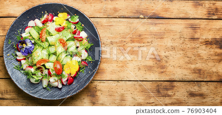 Spring vegetable salad with flowers,space for text Spring vegetable salad with flowers,space for text 76903404