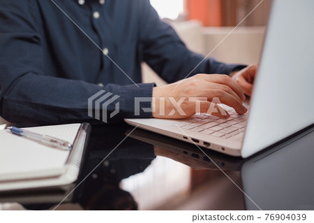 Businessman or student using laptop at home Businessman or student using laptop at home 76904039