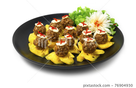 Thai Appetizer Pineapple Fruits Served with Sweet and Savory Peanut and Minced Pork Sauce 76904930