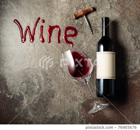 Red wine on an old rough background. Red wine on an old rough background. 76905676