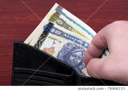 Eritrean money - Nakfa in a black wallet Eritrean money - Nakfa in a black wallet 76906153