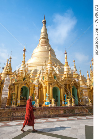 Buddhist monk walking in Shwedagon pagoda Buddhist monk walking in Shwedagon pagoda 76906872