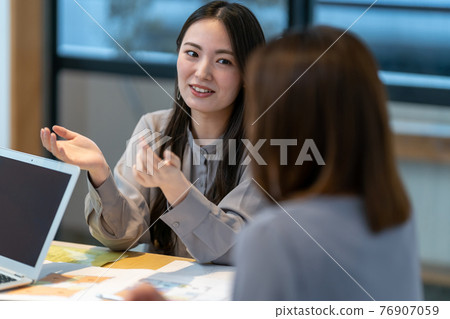 Business two women office desk work 76907059