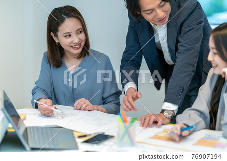 Three men and women architects having a meeting while looking at the floor plan of the house Business scene Three men and women architects having a meeting while looking at the floor plan of the house Business scene 76907194