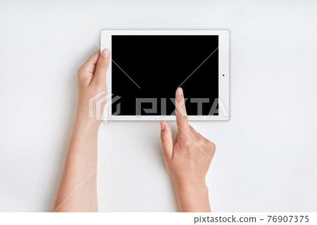 Female hands holds tablet computer with blank screen over white background. Hand touches blank screen of tablet computer. People, modern technologies concept. Woman uses tablet for advertising 76907375