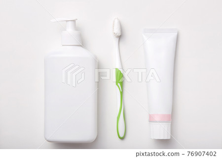 Composition of toothbrush, toothpaste and bottle of soap or gel isolated over white background. Cosmetic products. Flat lay 76907402