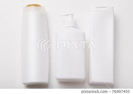 Horiontal shot of plastic bottles with beauty products, empty space for your design. Body care products. Cosmetic concept. Shampoo, lotion, cream Horiontal shot of plastic bottles with beauty products, empty space for your design. Body care products. Cosmetic concept. Shampoo, lotion, cream 76907405