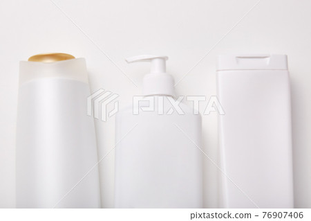 Cosmetic products in containers with empty space for your advertisement. Collection of cream, shampoo, shower gel and soap. Realistic package 76907406