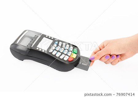 Woman pays with credit card via POS terminal in shop. Modern technologies and electronic payment concept. Hand swips magnetic card on POS terminal Woman pays with credit card via POS terminal in shop. Modern technologies and electronic payment concept. Hand swips magnetic card on POS terminal 76907414