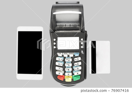 Modern technology and shopping online concept. POS terminal, modern smart phone and credit card isolated on grey background, show cashless payment. 76907416