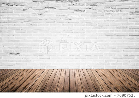 Old interior room with brick wall and wood floor 76907523