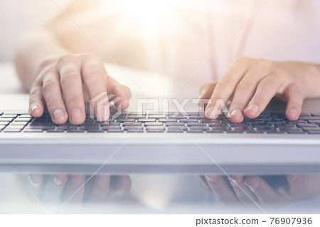 Woman typing on keyboard of PC on white background, female writing text on note book, man hands on keyboard, lap top on table, faceless portrait, programmer working online. Technology concept. 76907936