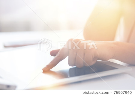 Technology, internet and home concept. Close up faceless portrait of female pointing finger to black blank screen of tablet. Programmer or designer working online and using wireless Internet. Technology, internet and home concept. Close up faceless portrait of female pointing finger to black blank screen of tablet. Programmer or designer working online and using wireless Internet. 76907940