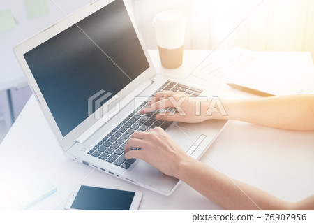 Close up of old woman's hands on keyboard of lap top, people working at home, using pc and smartphone concept, modern white notebook with blank screen on table. Internrt, work, technology concept. Close up of old woman's hands on keyboard of lap top, people working at home, using pc and smartphone concept, modern white notebook with blank screen on table. Internrt, work, technology concept. 76907956