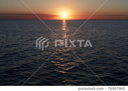 Beautiful panoramic view of sunset over sea. Colorful bright sunset with reflextion in water. Abstract sunset sky. Scenic seascape at evening. Summer sea, nature background. Sea wave on beach 76907960