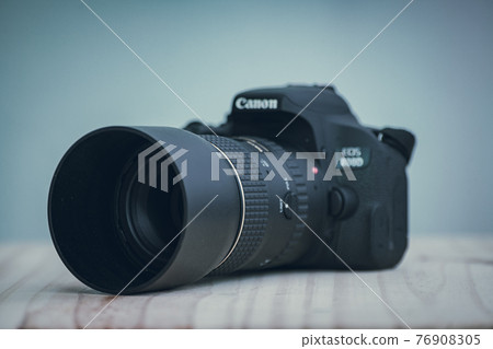 Galle, Sri Lanka - 02 18 2021: Canon EOS Rebel t7i DSLR camera and a prime lens with the lens hood on, Canon logo on top with the model name. Galle, Sri Lanka - 02 18 2021: Canon EOS Rebel t7i DSLR camera and a prime lens with the lens hood on, Canon logo on top with the model name. 76908305