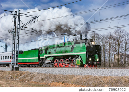 Steam retro train moves from the station. Steam retro train moves from the station. 76908922
