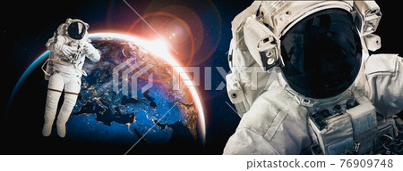 Astronaut spaceman do spacewalk while working for space station 76909748