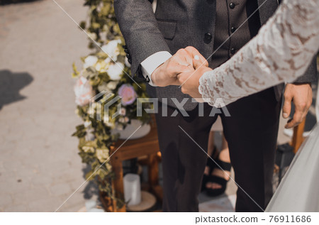 man and woman holding hands. wedding rings bride and groom 76911686