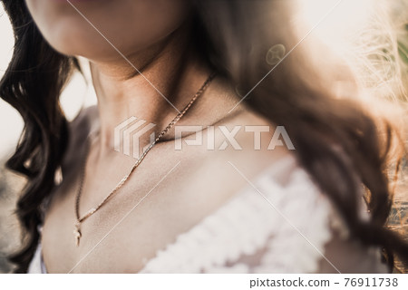 bride in a wedding dress on a background of sunbeams 76911738