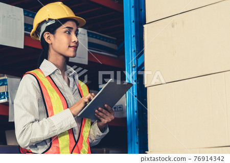 Female warehouse worker working at the storehouse Female warehouse worker working at the storehouse 76914342