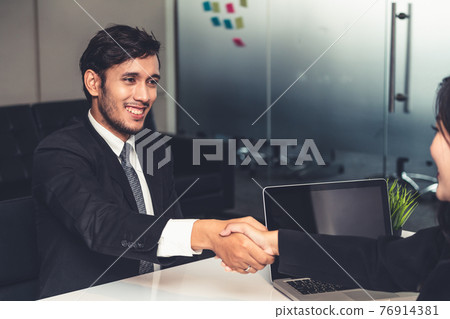 Business people handshake agreement in office. 76914381