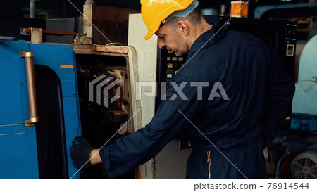 Skillful factory engineer or worker do machine job in manufacturing workshop Skillful factory engineer or worker do machine job in manufacturing workshop 76914544