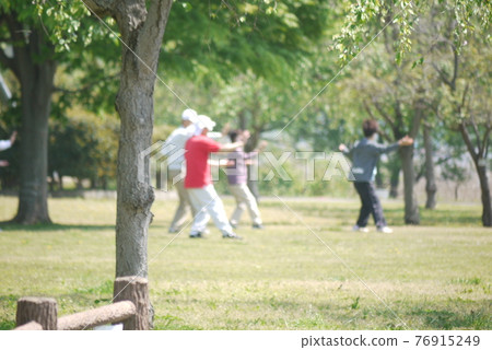 An elegant dance of Tai Chi in a holiday park An elegant dance of Tai Chi in a holiday park 76915249
