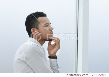 side view. portrait of a modern young businessman side view. portrait of a modern young businessman 76915985