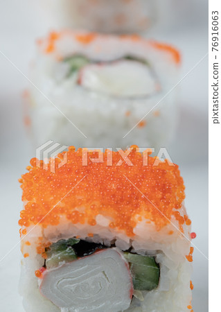 Salmon sushi rolls with red caviar and seafoods 76916063