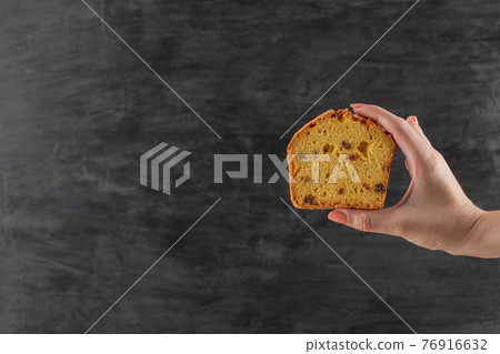 Holding a slice of pie with black sultana in it Holding a slice of pie with black sultana in it 76916632
