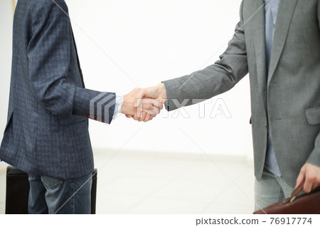 close up.handshake of two business people before the business me 76917774