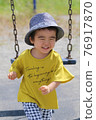 A 3-year-old boy having a good time in the park 76917870