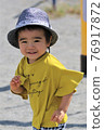 A 3-year-old boy having a good time in the park 76917872