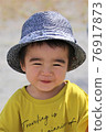 A 3-year-old boy having a good time in the park 76917873