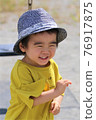 A 3-year-old boy having a good time in the park 76917875