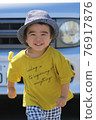 A 3-year-old boy having a good time in the park 76917876
