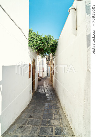 Narrow steep streets with houses whitewashed walls Narrow steep streets with houses whitewashed walls 76919505