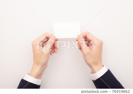 Hands handing out business cards, blank business cards Hands handing out business cards, blank business cards 76919662