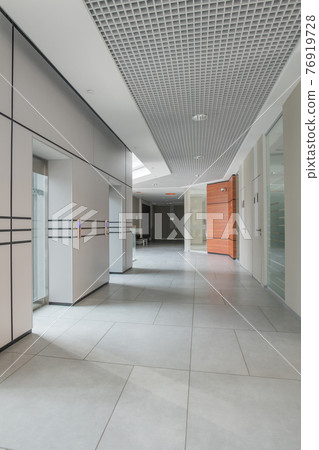 Empty corridor of business center 76919728