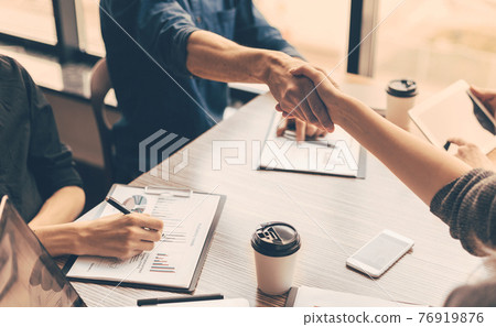 close up. handshake of business people in the office. 76919876