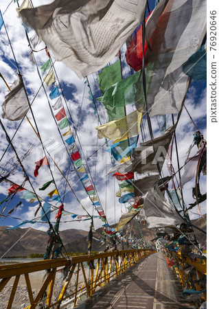 Prayer flags on a footbridge - Tibet Prayer flags on a footbridge - Tibet 76920646