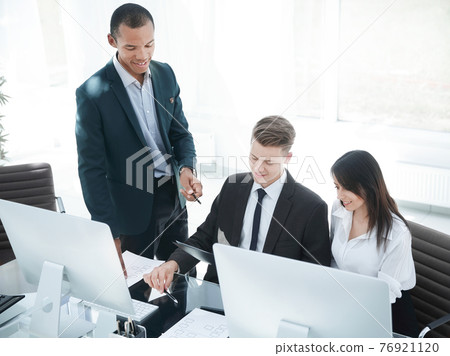 business team discussing business documents in the workplace. business team discussing business documents in the workplace. 76921120