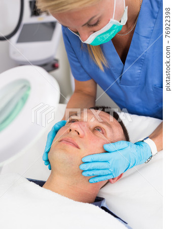 Woman specialist is massaging skin of patient before the procedure 76922398